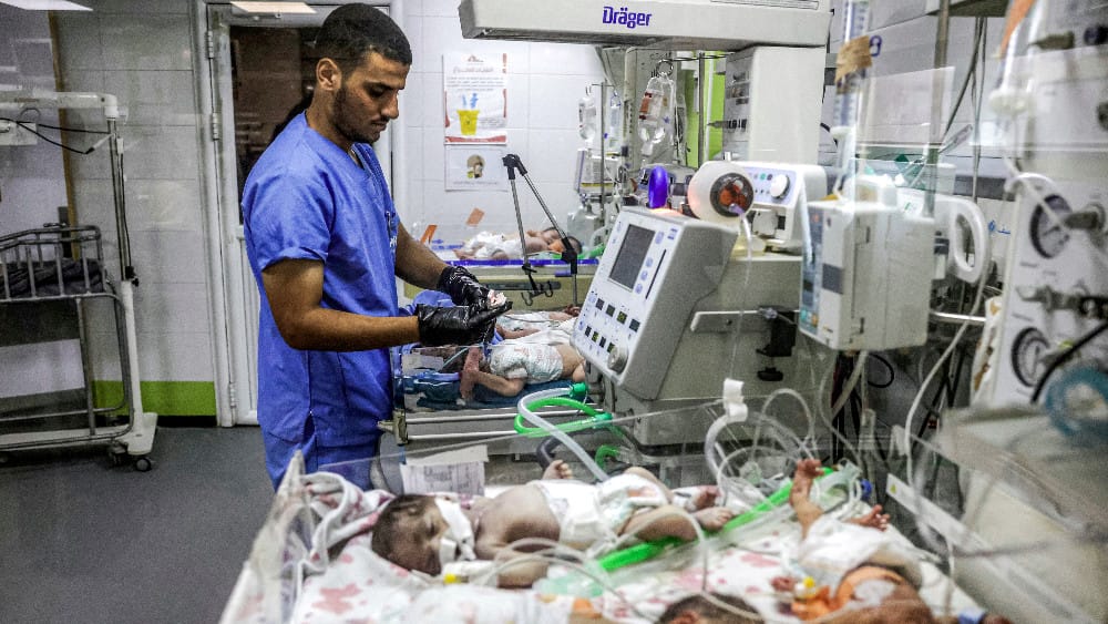 A medical worker checks on prematurely-born babies lying in infant warmer beds at the overcrowed neonatal intensive care unit (NICU) at Nasser Medical Complex in Khan Yunis in the southern Gaza Strip on September 7, 2026. (AFP)