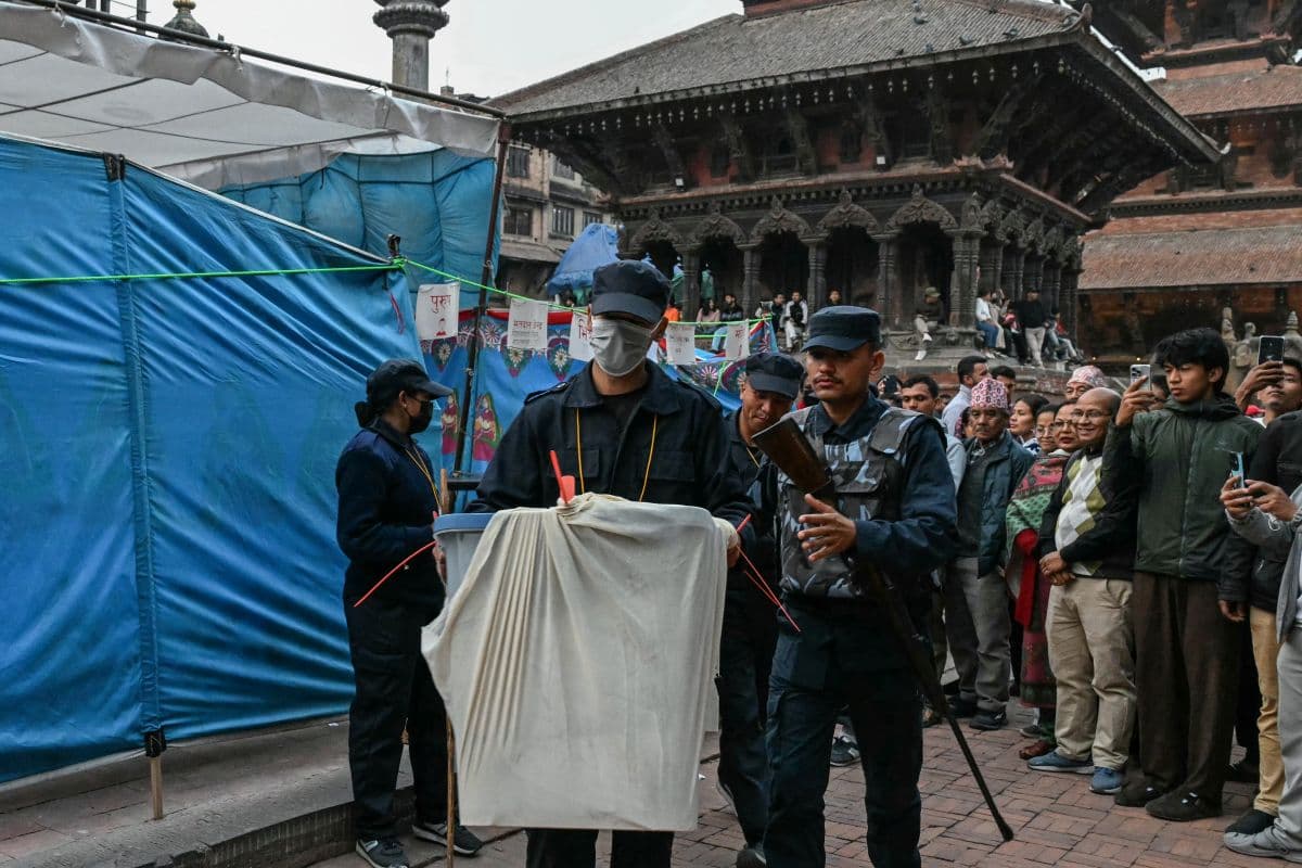Security personnel and electoral officials carry ballot boxes to the counting centre after voting ends at a polling station during Nepal's general election in Lalitpur on March 5, 2026. (AFP)