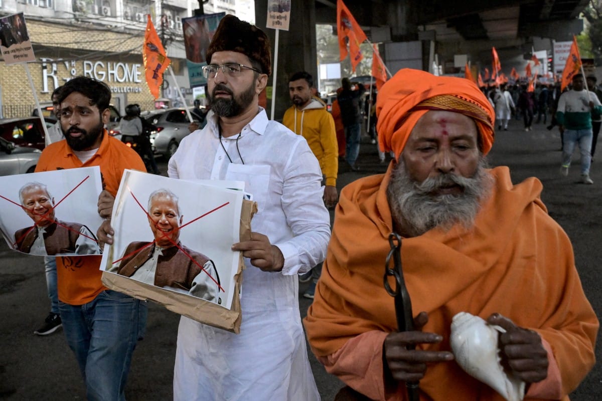 Bharatiya Janata Party (BJP) and religious activists with posters of Muhammad Yunus, Chief Adviser of Bangladesh's interim government shout slogans during a protest near the Deputy High Commission of Bangladesh office in Kolkata on December 22, 2025.