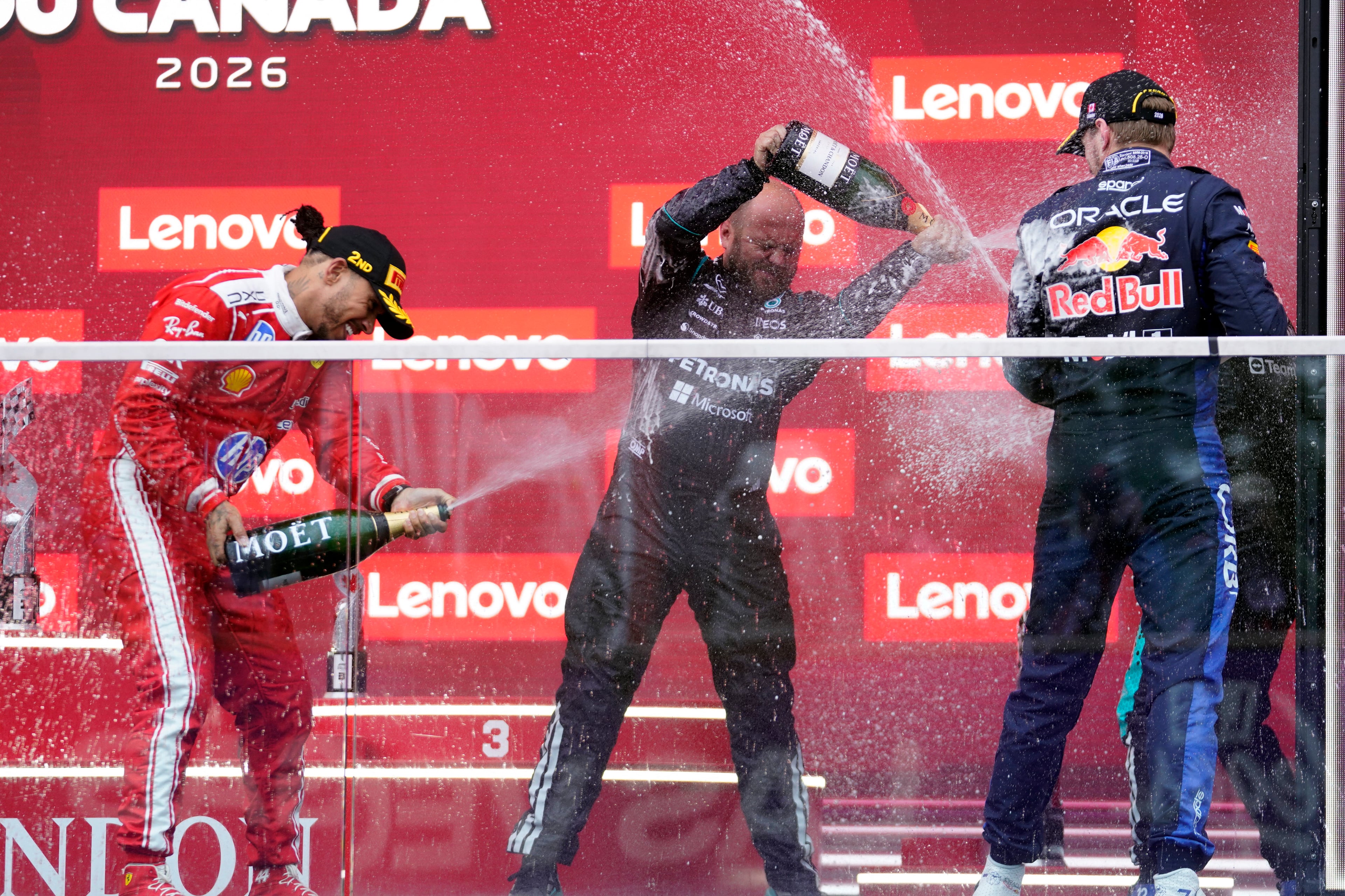 (L/R) Ferrari's British driver Lewis Hamilton, Mercedes' Senior Race Team Composite Technician Dean Hale, Red Bull Racing's Dutch driver Max Verstappen and race winner Mercedes' Italian driver Kimi Antonelli (hidden) celebrate on the podium at the conclus