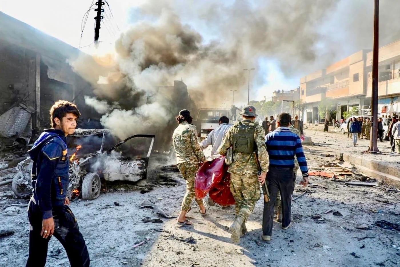FILE: Pro-Turkish Syrian fighters carry away the victim of a car-bomb explosion last November in Tal Abyad (AFP)