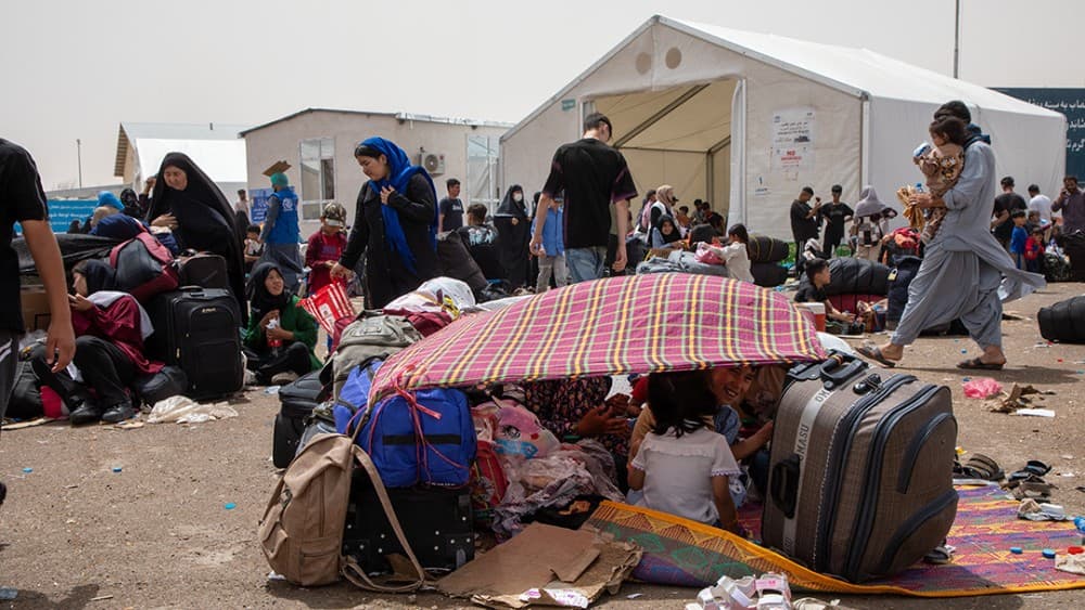 FILE: Afghan families rest under makeshift shelters at the Islam Qala crossing on July 4, 2025. (Photo: Council on Foreign Relations)