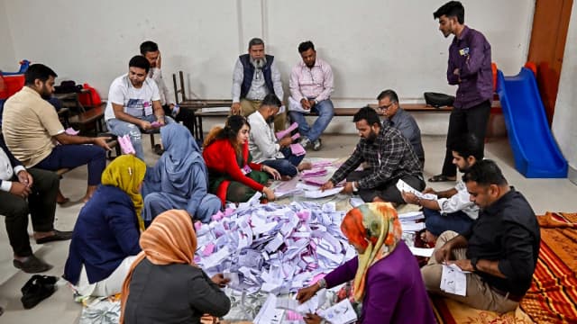Electoral officials sort ballots as counting starts at a polling station during Bangladesh's general election in Dhaka on February 12, 2026. Counting began on February 12 in Bangladesh's first election since a deadly 2024 uprising, with powerful political