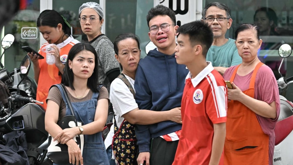 People gather outside a school following a shooting in Bang Kruai district, Nonthaburi province, north of Thailand's capital Bangkok, on August 7, 2026.