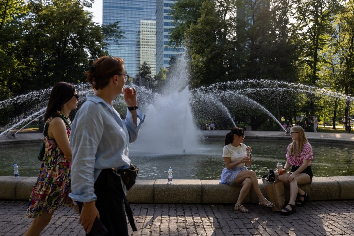 Residents of Warsaw cool off near a fountain in the city centre during the heatwave that has reached Poland on June 27, 2026. (Photo: AFP)