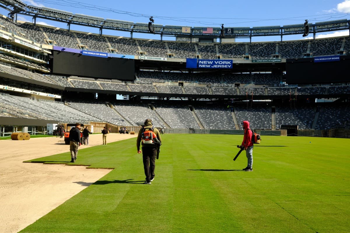 Workers install the pitch at New York New Jersey Stadium ahead of the 2026 FIFA World Cup, in East Rutherford, New Jersey, on May 7, 2026. (Photo by CHARLY TRIBALLEAU / AFP)