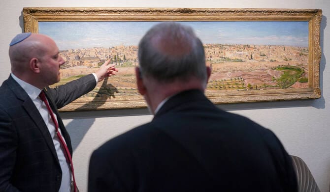 US Ambassador to Israel Mike Huckabee (R) is shown a painting of Jerusalem during a visit to the Beit Hanassi presidential residence, in Jerusalem, on September 15, 2025. (AFP)