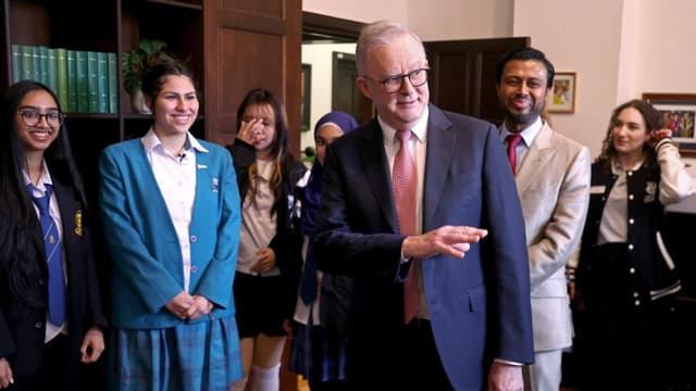 Australia’s Prime Minister Anthony Albanese (C) speaks with students after speaking at an official event at Sydney University in Sydney on July 15, 2026.