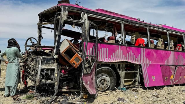 Bystanders look at the wreckage of a bus in Noshki town of Balochistan province on March 17, 2025, a day after an explosives laden car hit one of the seven buses of a convoy, a bombing carried out by the terrorist group Baloch Liberation Army (BLA). (AFP)