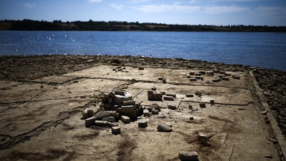 The remains of buildings revealed by the the persistent hot weather and drought, are pictured in the reservoir bed of Anglian Water's Rutland Water -- a reservoir created by the flooding of hamlets Lower and Middle Hambleton -- in Upper Hambleton, central