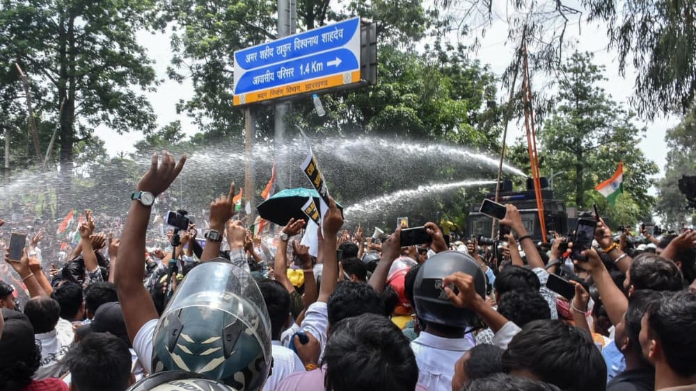 Police personnel use water cannon to disperse demonstrators during an ongoing protest against alleged irregularities in the Jharkhand Public Service Commission (JPSC) and Jharkhand Staff Selection Commission (JSSC) recruitment exams in Ranchi on August 10