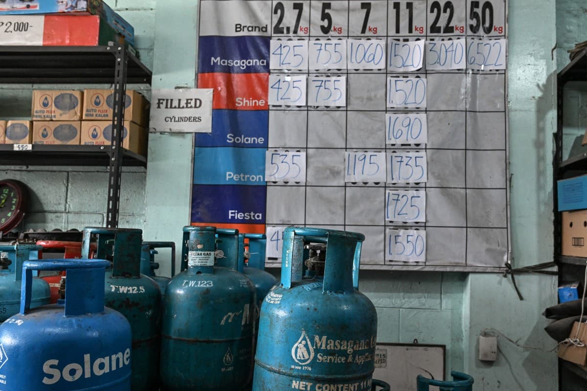 Prices for liquefied petroleum gas (LPG) are displayed next to canisters at a store in Manila on April 7, 2026. (Photo by Jam STA ROSA / AFP)