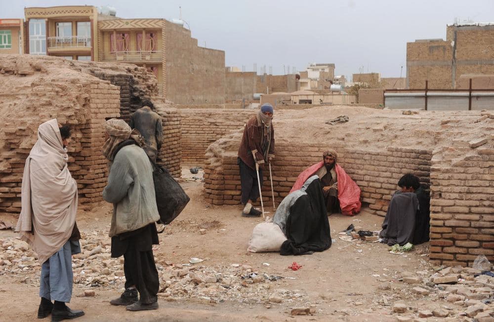 Afghan drug users get their fix near the ruins of historical minarets in the city of Herat. (AFP)