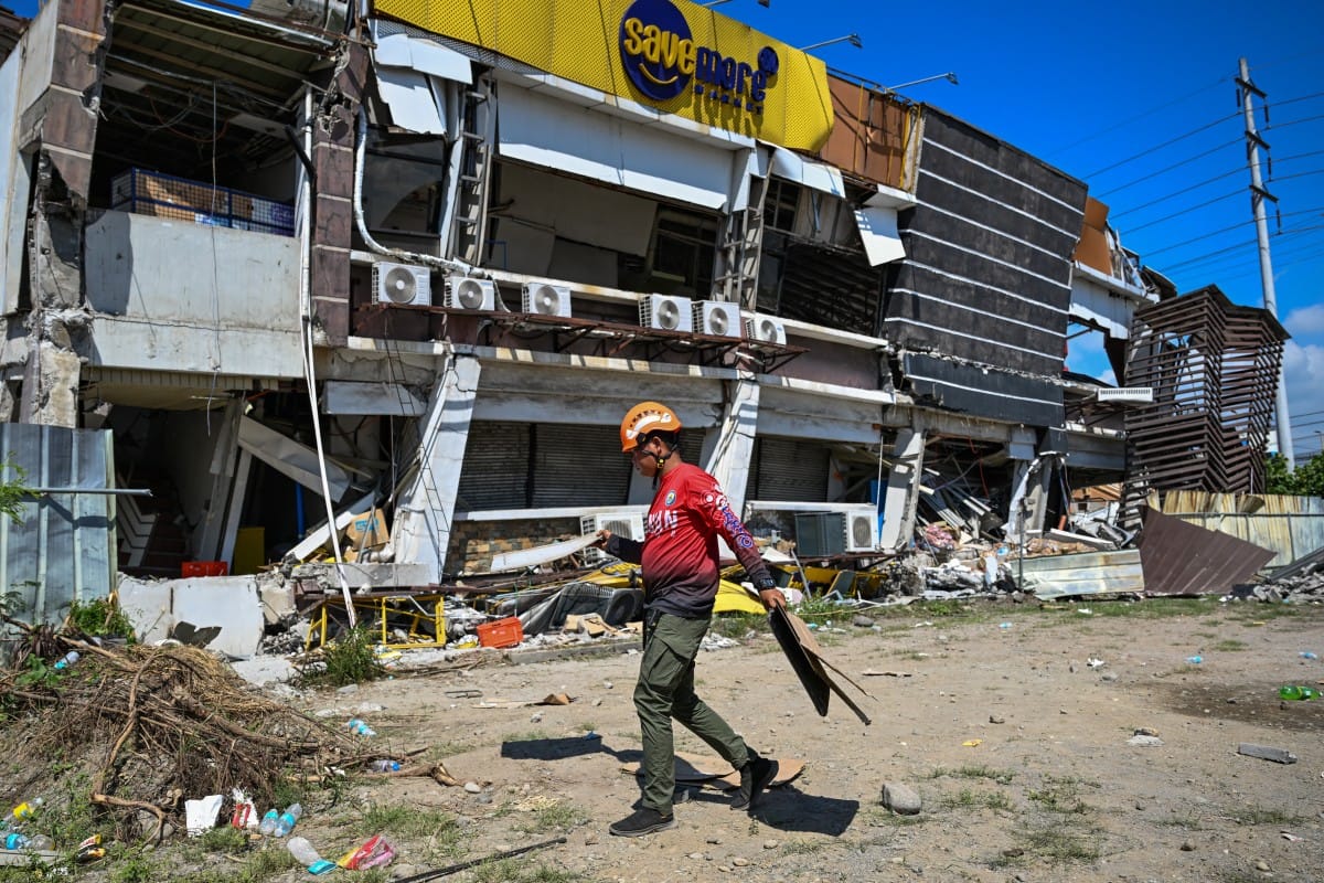 A responder prepares to take part in search and rescue operations outside a collapsed building after a 7.8 magnitude earthquake in General Santos City on June 9, 2026 (AFP)