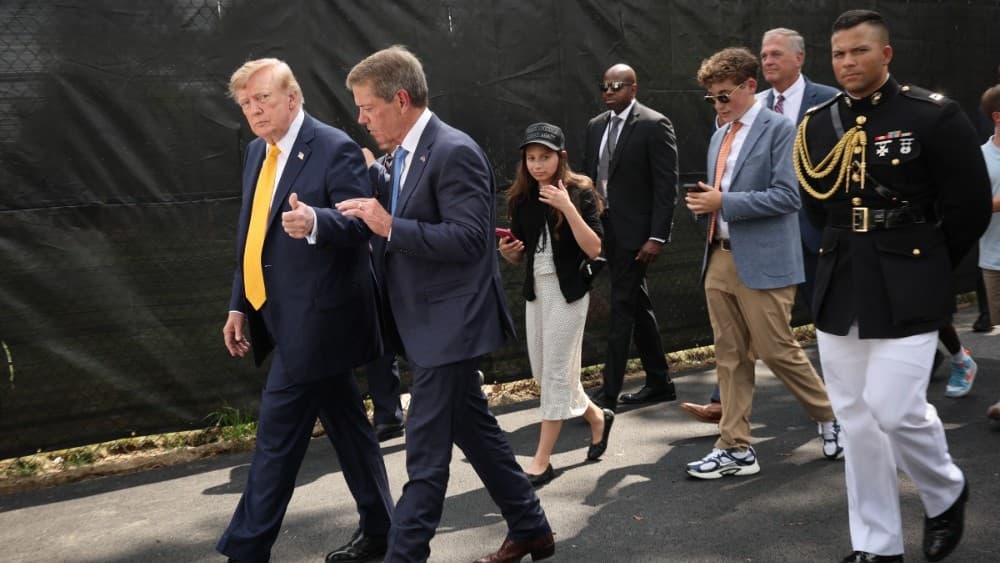 US President Donald Trump speaks with Nebraska Gov. Jim Pillen before touring the White House helipad construction on the South Lawn of the White House after an event in the Rose Garden on August 24, 2026, in Washington, DC. (Photo by WIN MCNAMEE / GETTY