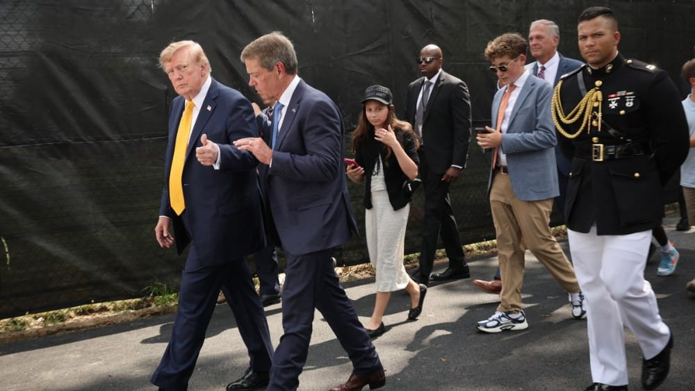 US President Donald Trump speaks with Nebraska Gov. Jim Pillen before touring the White House helipad construction on the South Lawn of the White House after an event in the Rose Garden on August 24, 2026, in Washington, DC. (Photo by WIN MCNAMEE / GETTY