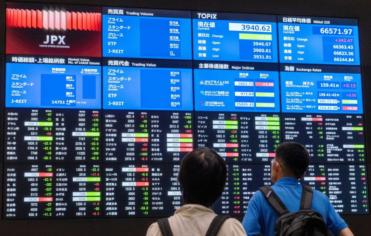 Visitors look at electronic display boards showing stock prices and economic indicators at the Tokyo Stock Exchange in Tokyo on June 1, 2026. (Photo by Kazuhiro NOGI / AFP)