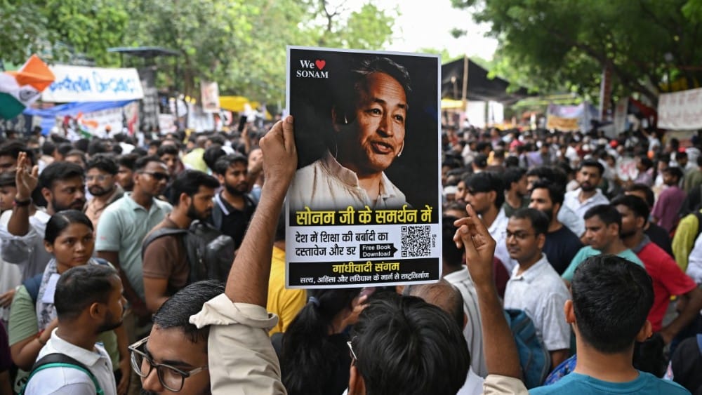 A supporter holds a photograph of climate activist Sonam Wangchuk during a sit-in protest demanding the resignation of India's Education Minister Dharmendra Pradhan over alleged NEET examination irregularities in New Delhi on July 19, 2026. (AFP)