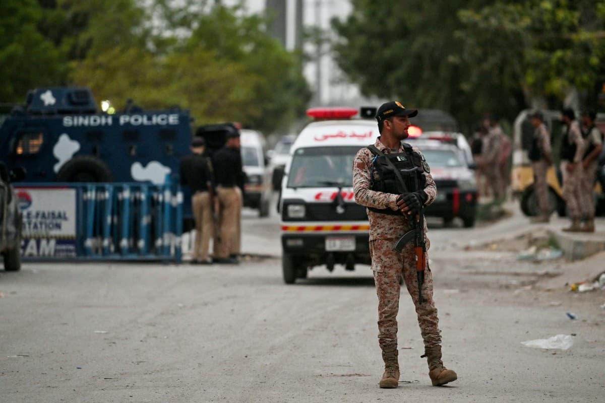 A security personnel stands guard at the end of a clearance operation following an explosion and a terrorist attack in Karachi on June 28, 2026. (AFP)