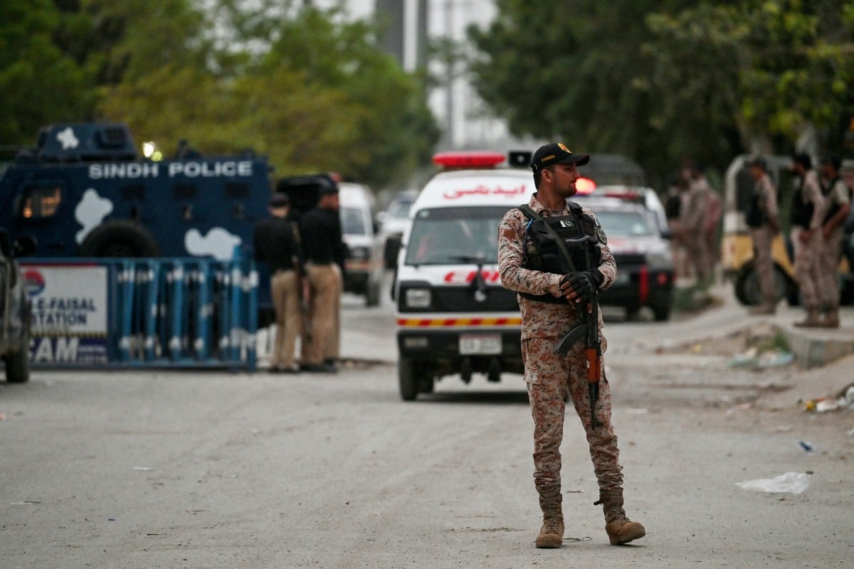 A security personnel stands guard at the end of a clearance operation following an explosion and a terrorist attack in Karachi on June 28, 2026. (AFP)
