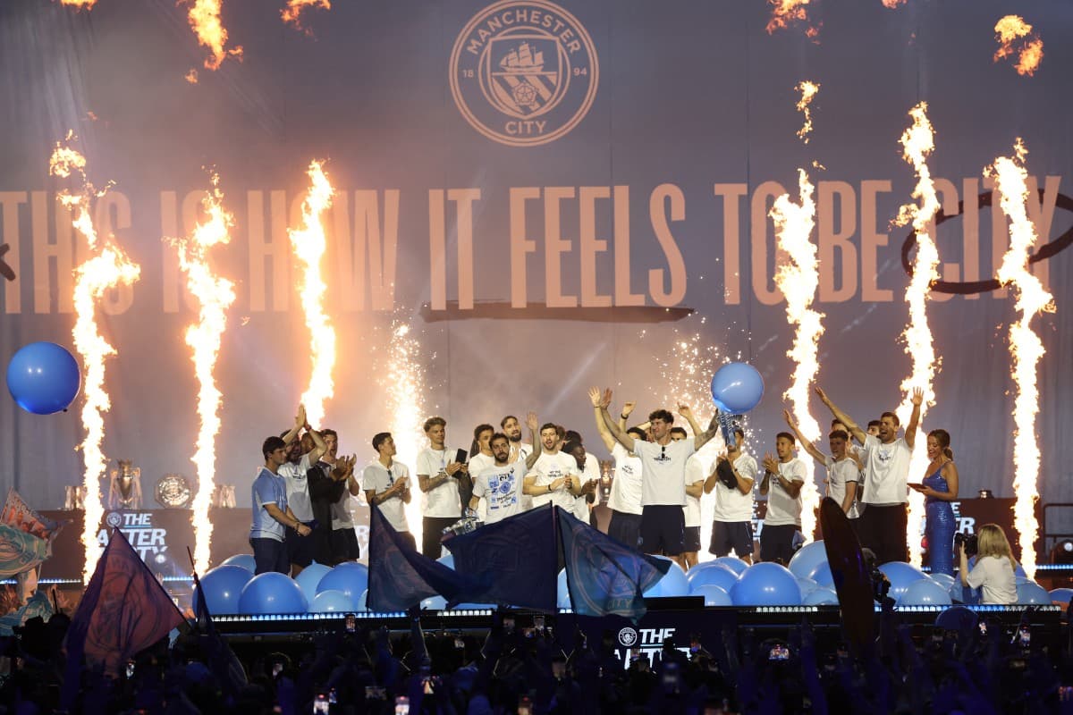 Manchester City's English defender #05 John Stones (centre right) and Manchester City's Portuguese midfielder #20 Bernardo Silva (centre left) say goodbye at an after-party event with the players after their victories in the two domestic cup competitions