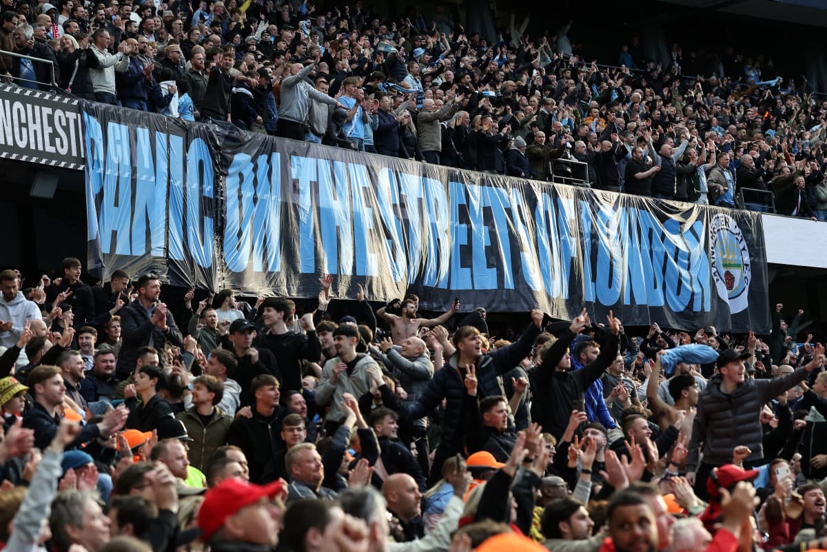 Manchester City supporters cheer at the end of the English Premier League football match between Manchester City and Arsenal at the Etihad Stadium in Manchester, north west England, on April 19, 2026. (AFP)