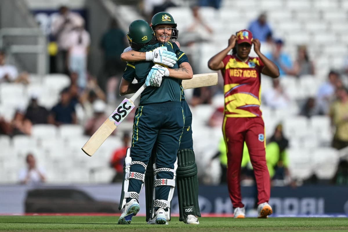 Australia's Beth Mooney (L) and Australia's Ashleigh Gardner (C-facing) embrace as they celebrate the team's victory in the ICC Women's T20 cricket World Cup 2026 semi-final game between Australia and West Indies, at The Oval in London on June 30, 2026. (