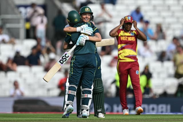 Australia's Beth Mooney (L) and Australia's Ashleigh Gardner (C-facing) embrace as they celebrate the team's victory in the ICC Women's T20 cricket World Cup 2026 semi-final game between Australia and West Indies, at The Oval in London on June 30, 2026. (
