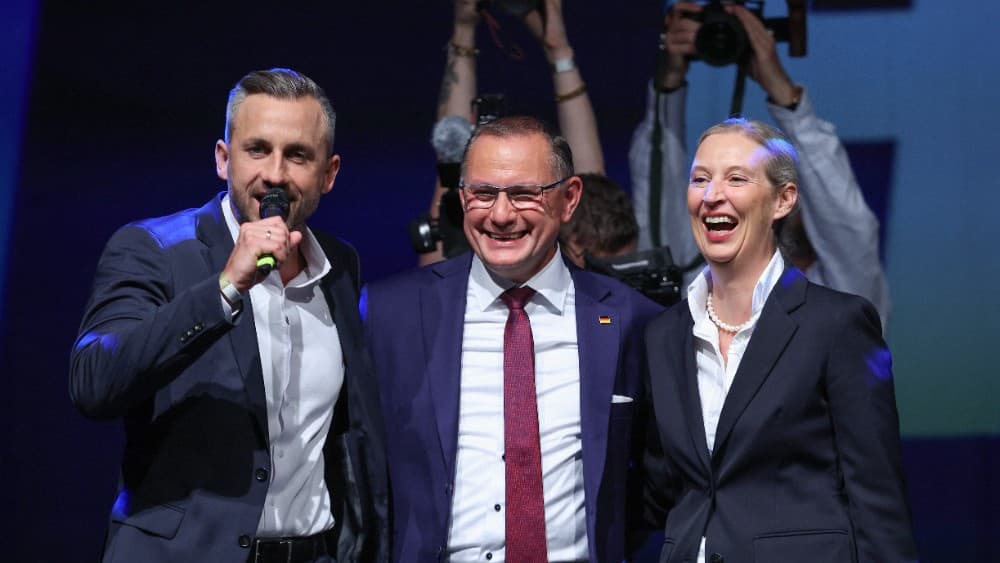 Ulrich Siegmund (L), far-right Alternative for Germany (AfD)'s main candidate in the Saxony-Anhalt state election, addresses supporters next AfD co-leaders Tino Chrupalla and Alice Weidel (R) at the AfD's election party following Saxony-Anhalt's state ele