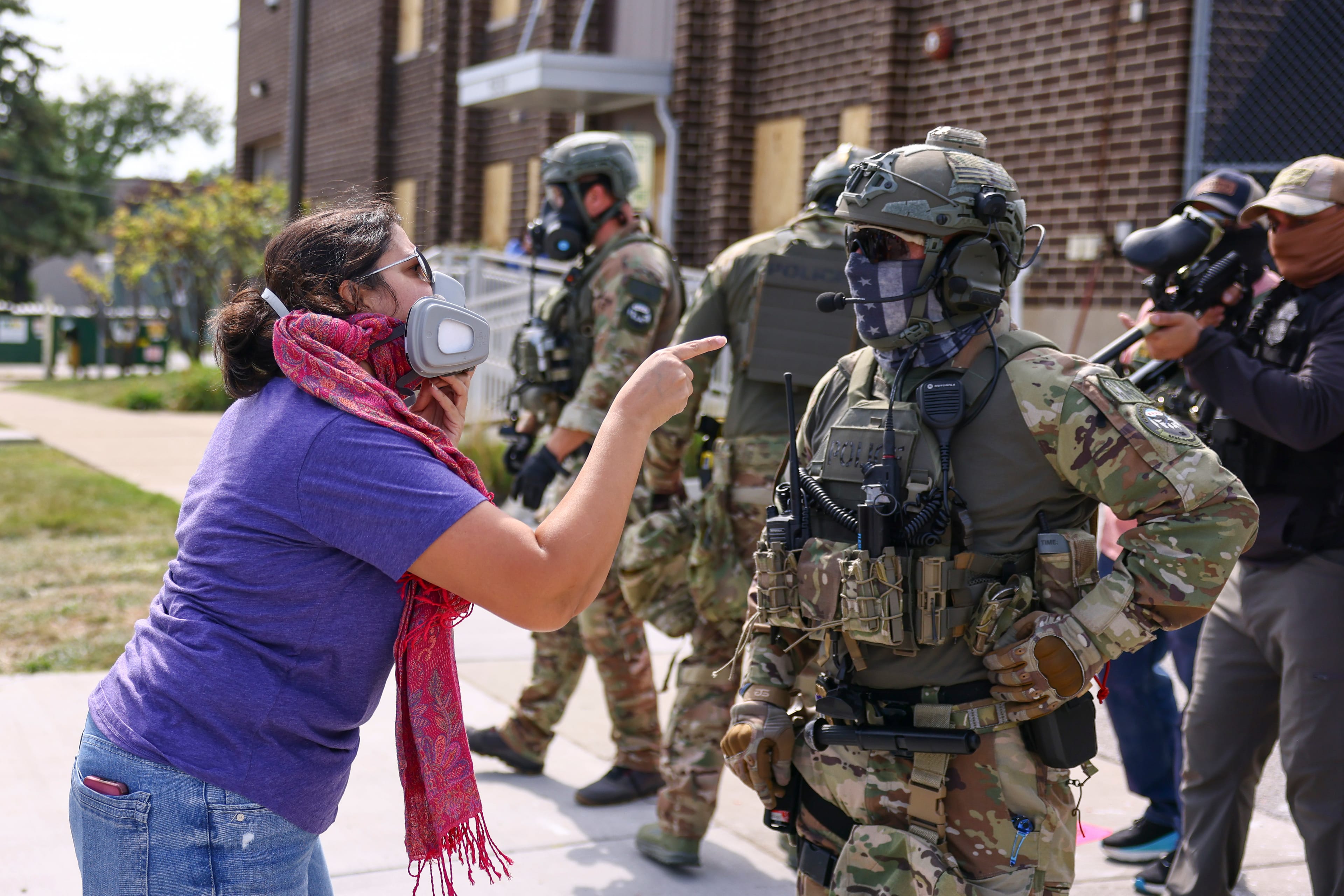 A protester confronts an Immigration and Customs Enforcement officer outside of an ICE facility in Broadview, Friday, Sept. 19, 2025. (Anthony Vazquez/Chicago Sun-Times via AP)