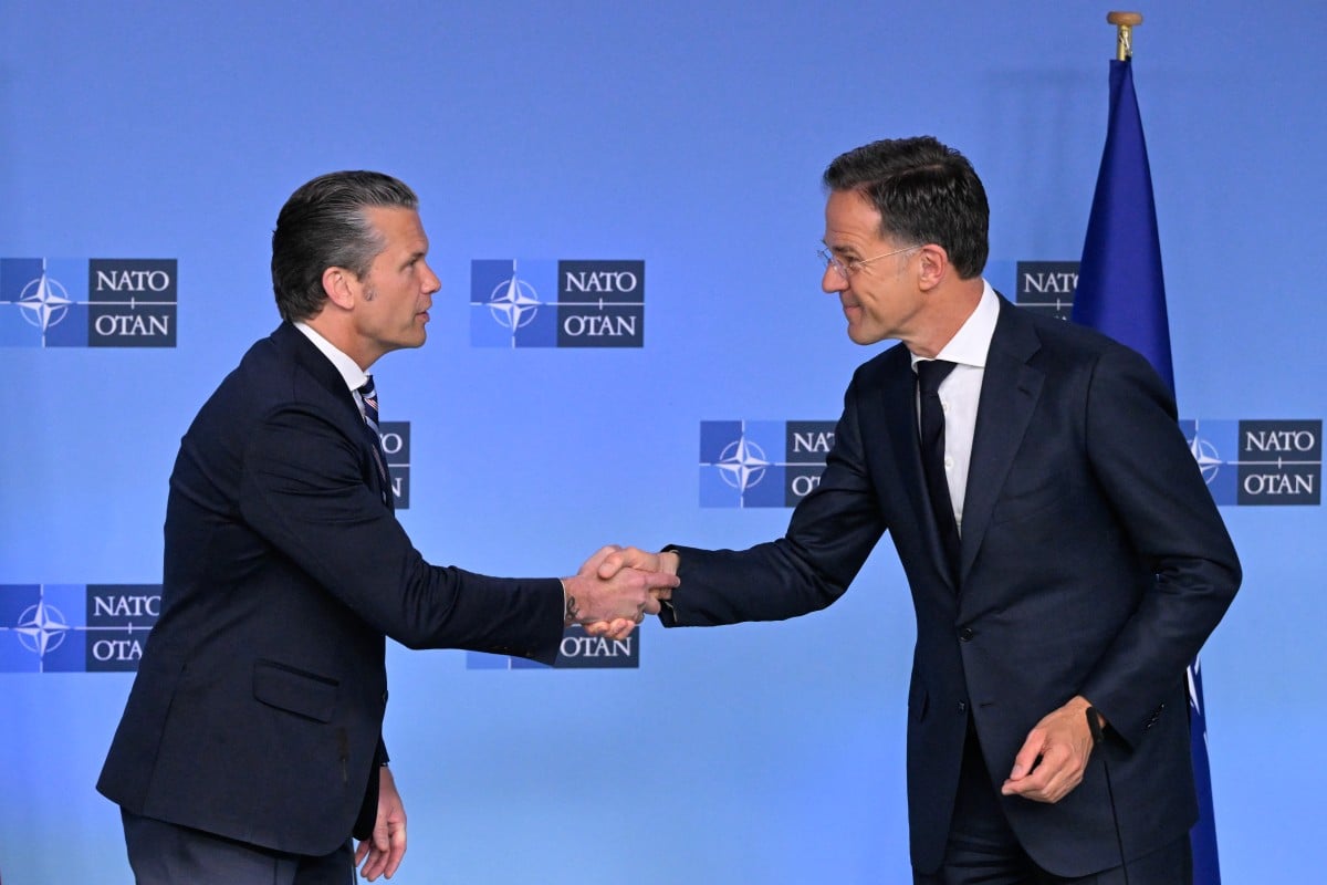 US Secretary of Defence Pete Hegseth (L) and NATO Secretary General Mark Rutte shake hands prior to delivering remarks before a NATO Defence Ministers meeting at the NATO headquarters, in Brussels, on June 18, 2026. (Photo by JOHN THYS / AFP)