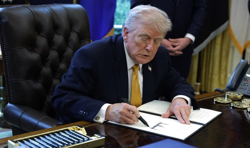 US President Donald Trump signs an executive order during a ceremony in the Oval Office of the White House on March 16, 2026, in Washington, DC (AFP)