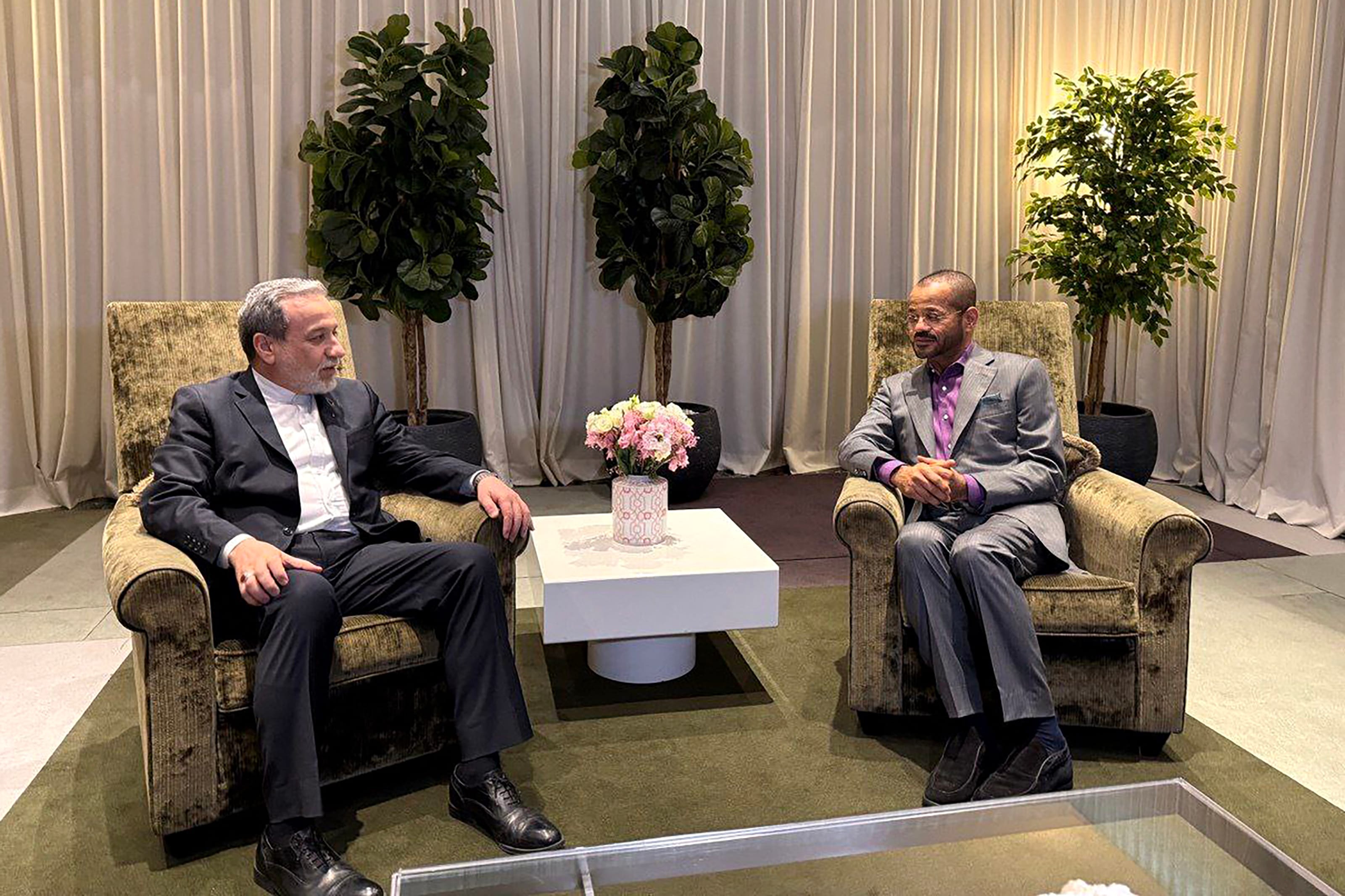 In this handout photo released by the Iran's Foreign Ministry on February 26, 2026, Iran's Foreign Minister Abbas Araghchi (L) speaks with Oman’s Foreign Minister Badr Albusaidi during their meeting in Geneva.