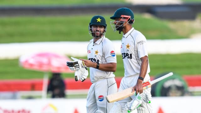 Salman Ali Agha (L) and Shan Masood (R) of Pakistan walk off the field at the end of the 2nd day of 1st Test match between West Indies and Pakistan at Brian Lara Cricket Academy in Tarouba, Trinidad and Tobago on July 26, 2026. (Photo: AFP)