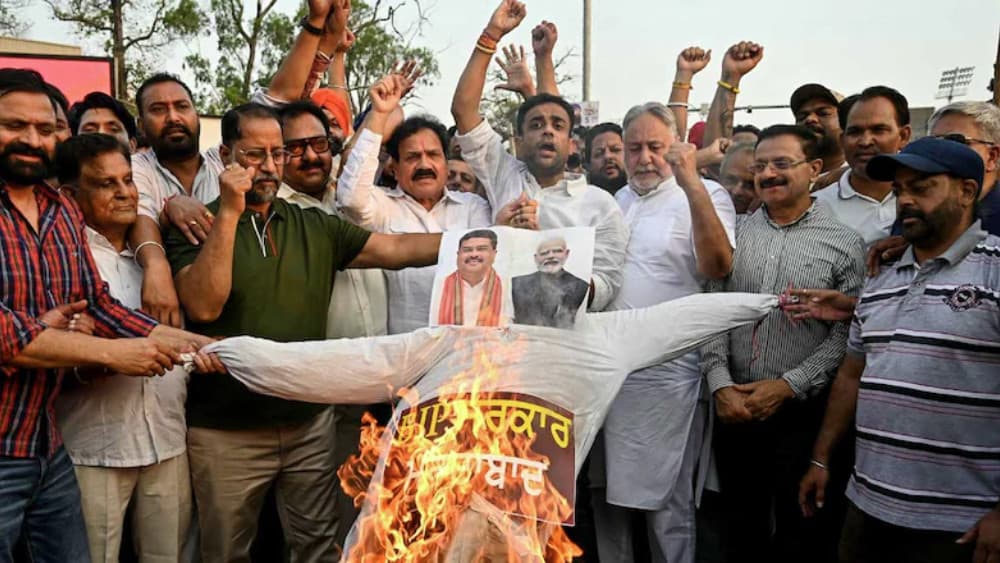 Indian National Congress party workers burn an effigy of India's Prime Minister Narendra Modi and Education Minister Dharmendra Pradhan during a protest in Amritsar on June 2, 2026. (AFP)