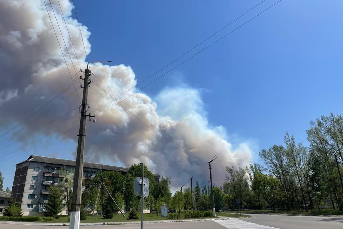 This handout photograph, taken and released by the Ukrainian Chernobyl Radiation and Ecological Biosphere Reserve on May 8, 2026, shows smoke billowing over buildings in the town of Chernobyl from a forest fire in the Chernobyl Exclusion Zone. (AFP)