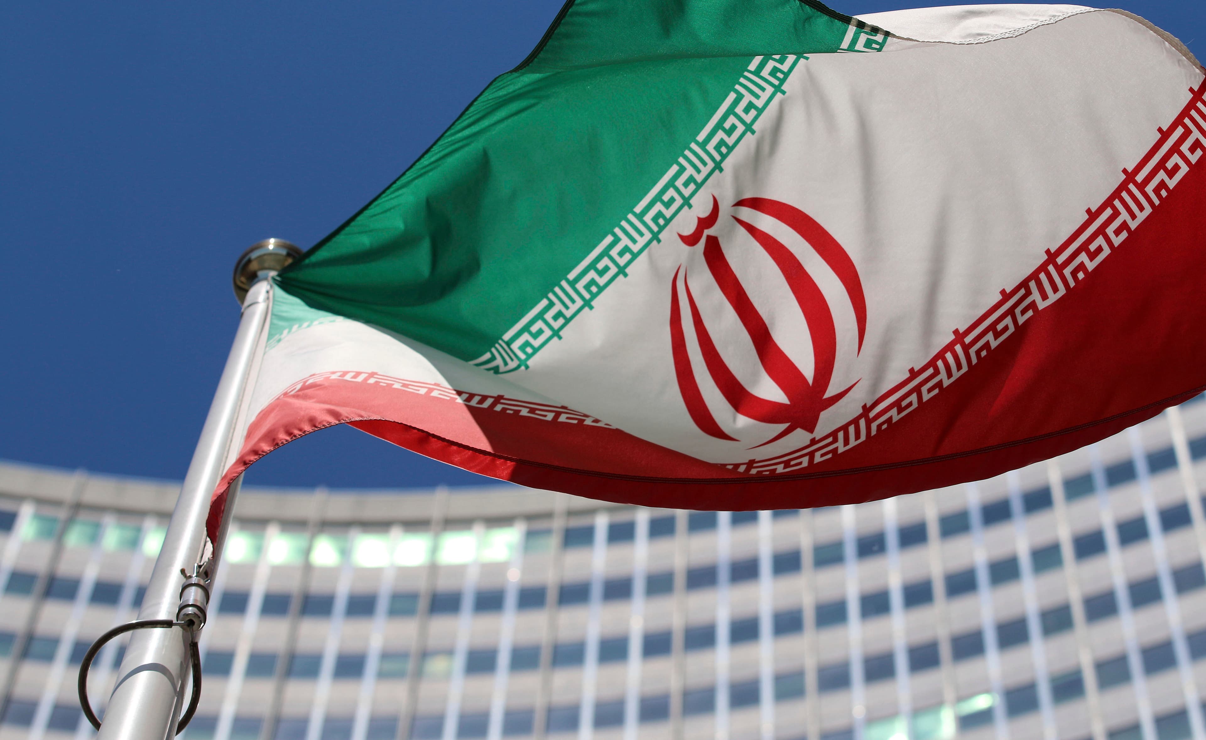 FILE - The Iranian flag flies in front of a U.N. building where closed-door nuclear talks take place at the International Center in Vienna, Austria, on June 18, 2014.