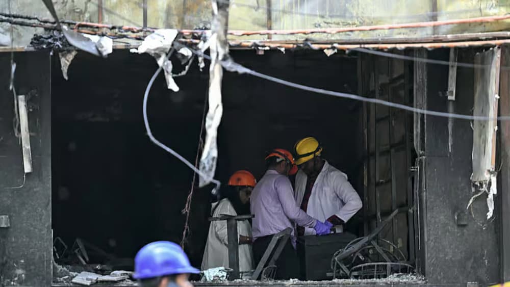 Forensics team members inspect the site following a fire that broke out at a hotel in New Delhi on June 3, 2026.(AFP)