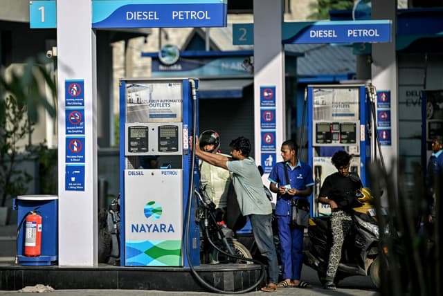 Customers refuel their vehicles at a gas station of Nayara Energy Limited, in Bengaluru on December 12, 2025. (File photo: AFP)