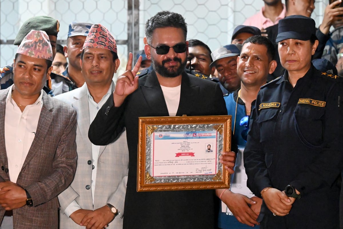 Rastriya Swatantra Party (RSP) election candidate Balendra Shah (C) shows a victory sign after collecting a certificate following his win in parliamentary elections at the counting centre in Damak in Nepal's Jhapa district on March 7, 2026.