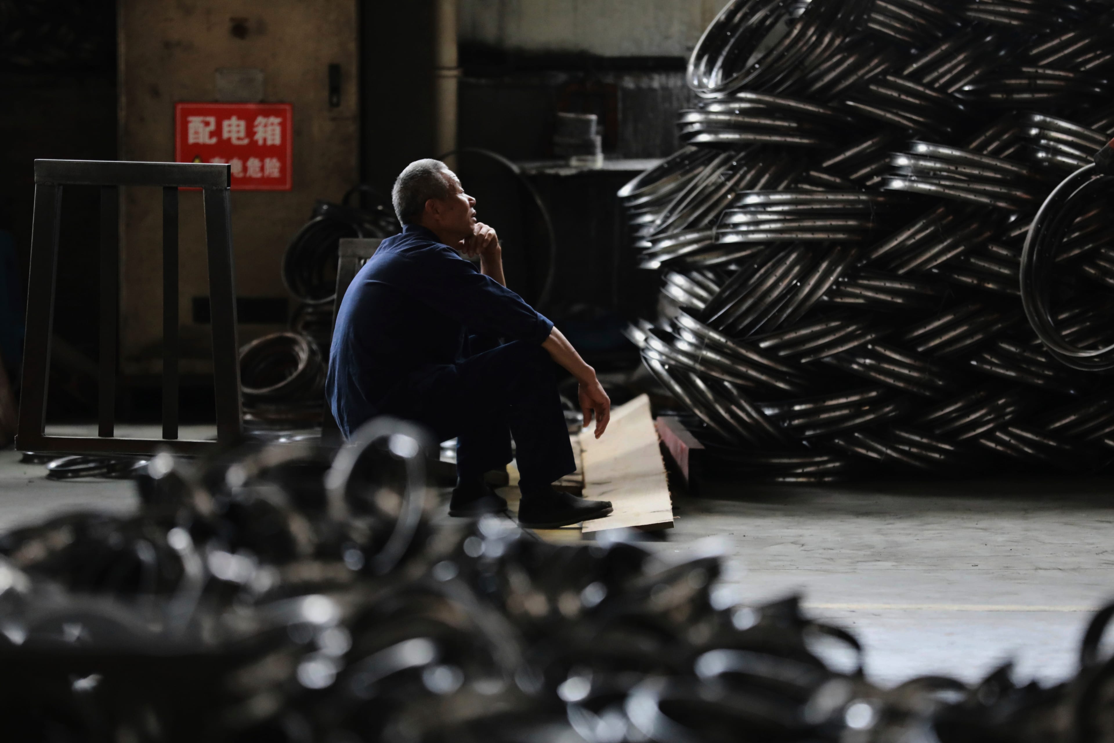 FILE - A worker takes a rest at a factory making steel bike rims for export to U.S., in Hangzhou in east China's Zhejiang province, on Friday, April 11, 2025.