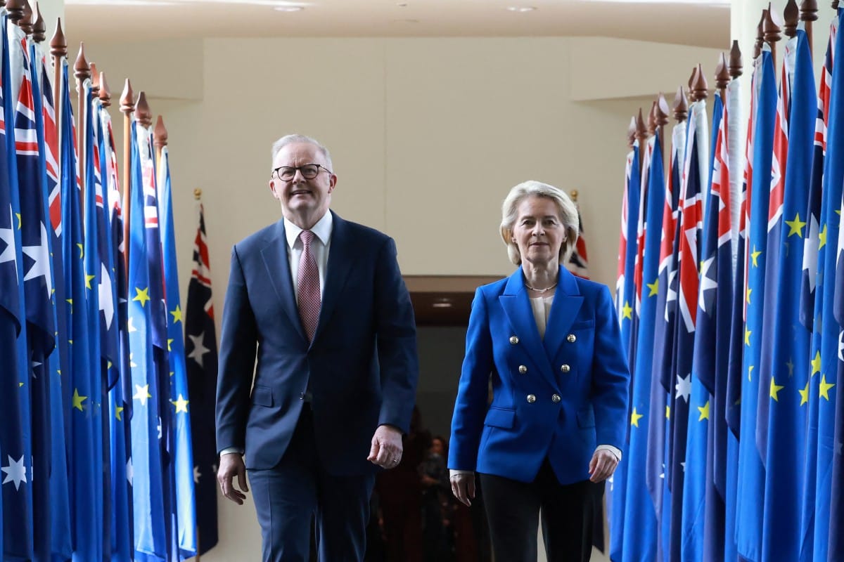 European Commission President Ursula von der Leyen (R) and Australian Prime Minister Anthony Albanese walk through the corridors of Parliament House in Canberra on March 24, 2026. (Photo by DAVID GRAY / AFP)