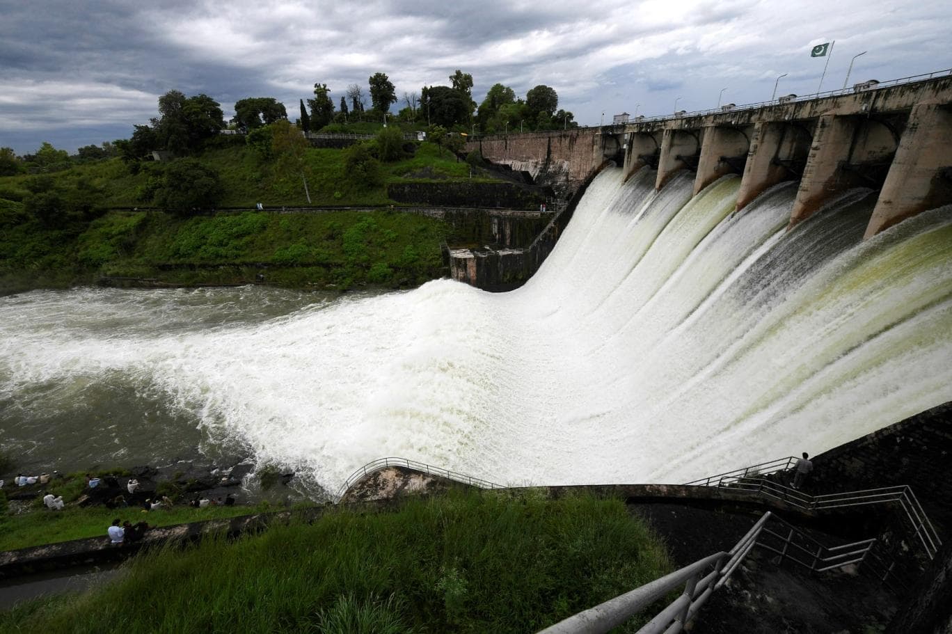 People watch the Rawal Dam after the spillway opened due to heavy monsoon rains, in Islamabad on August 31, 2020. (AFP)