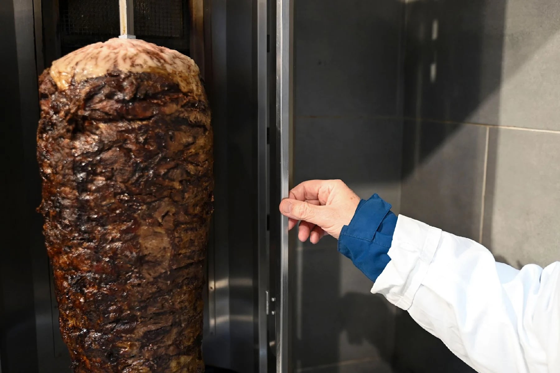A food inspector examines the kebab grill during an inspection in a snack bar in Stuttgart. (AFP)
