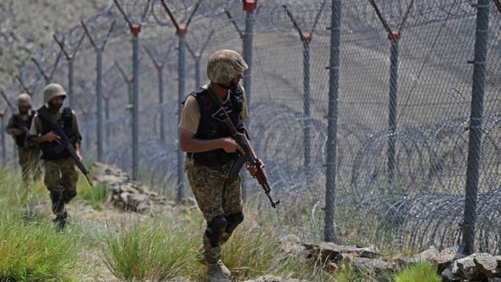 Pakistani troops patrol along Pakistan-Afghanistan border fence at Big Ben post in the Khyber district of the Khyber Pakhtunkhwa province on August 3, 2021. (AFP)
