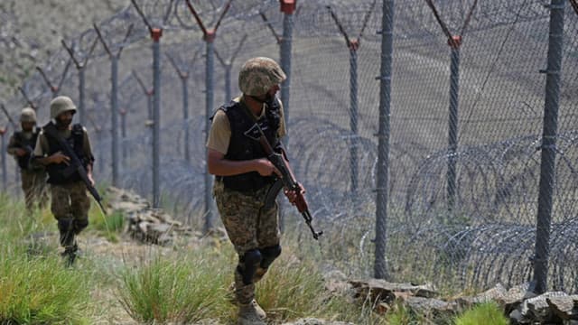 Pakistani troops patrol along Pakistan-Afghanistan border fence at Big Ben post in the Khyber district of the Khyber Pakhtunkhwa province on August 3, 2021. (AFP)