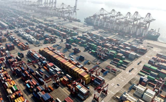 Cargo ships and containers are seen at the container terminal of the port in Qingdao, in China’s eastern Shandong province on April 2, 2026.