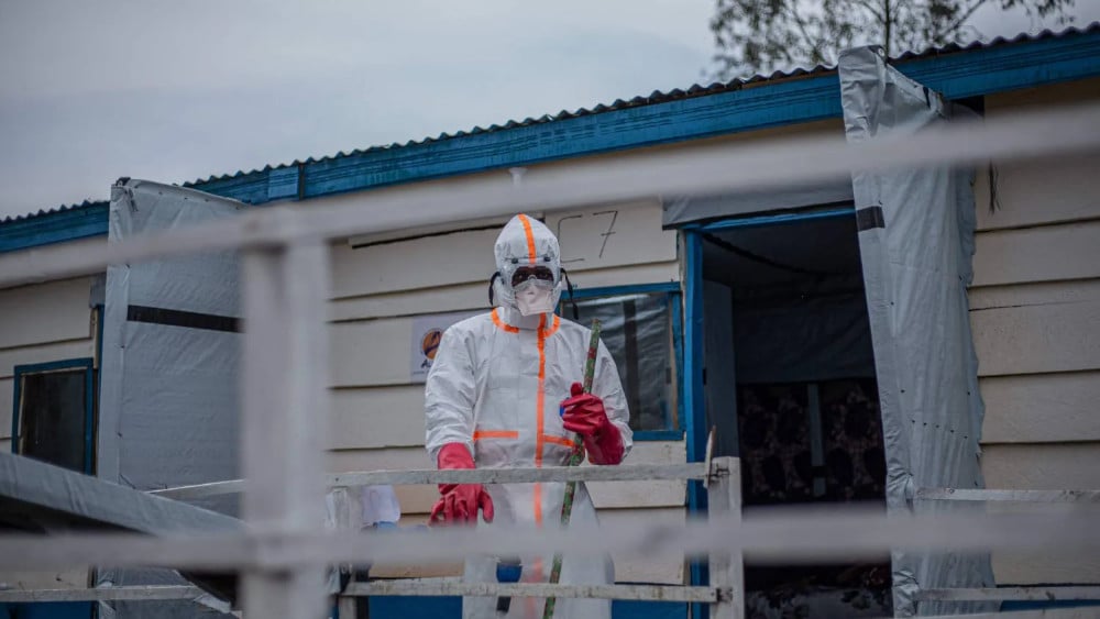 A hygienist wearing personal protective equipment (PPE) begins cleaning and disinfection operations at the Rwampara Ebola Treatment Centre (ETC) in Bunia, Ituri, in the east of the Democratic Republic of Congo on July 13, 2026. (AFP)