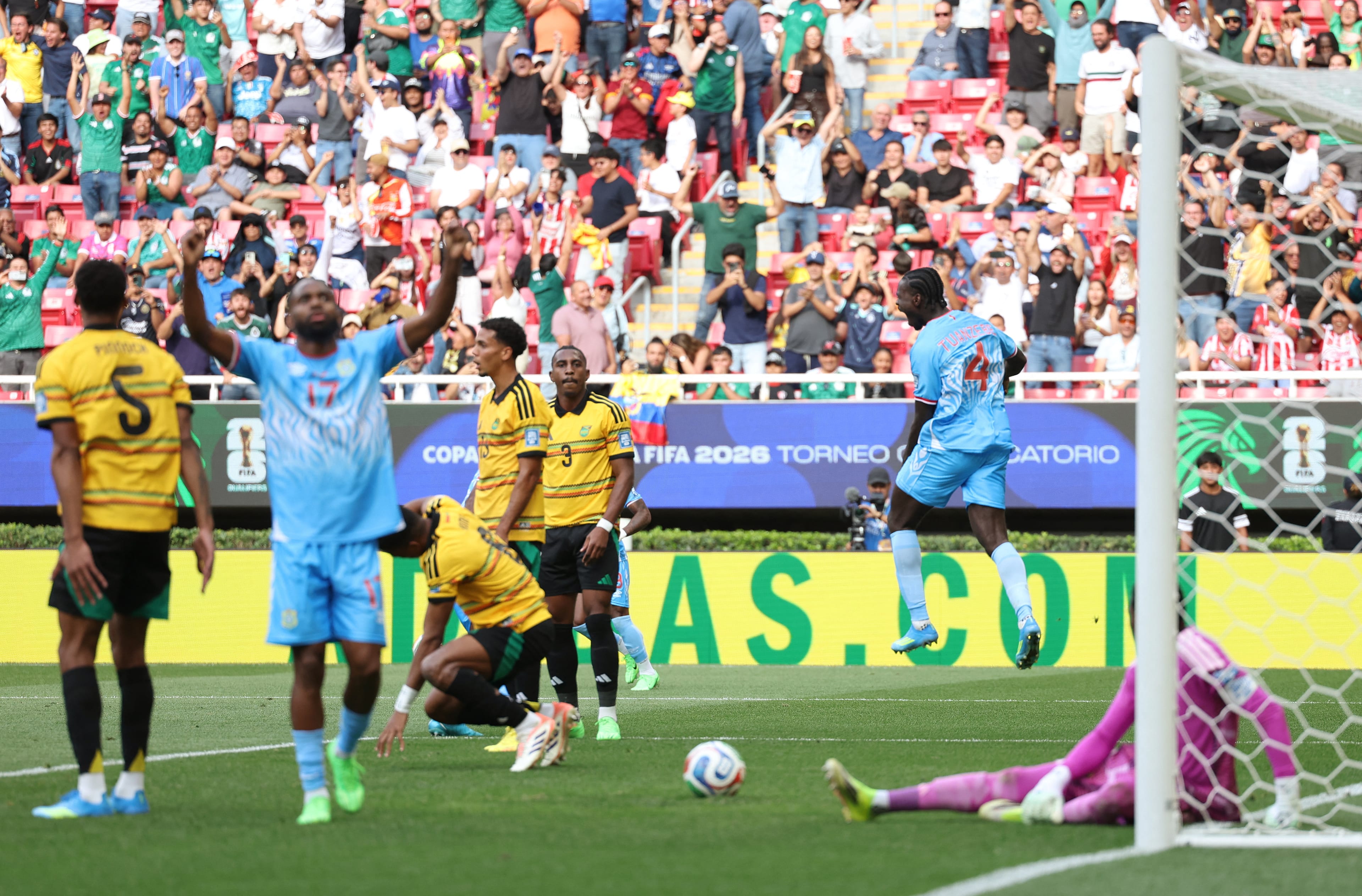 DR Congo's defender #04 Axel Tuanzebe (R) celebrates after scoring a goal in extra time during the 2026 FIFA World Cup qualifiers final playoff football match between the Democratic Republic of the Congo and Jamaica at the Akron Stadium in Zapopan, Jalisc