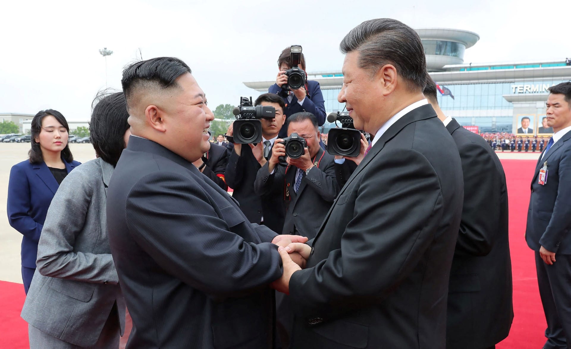 This June 21, 2019 picture released from North Korea's official Korean Central News Agency (KCNA) on June 22, 2019 shows China's President Xi Jinping (centre R) speaking with North Korean leader Kim Jong Un (front L) upon his departure at the airport in P